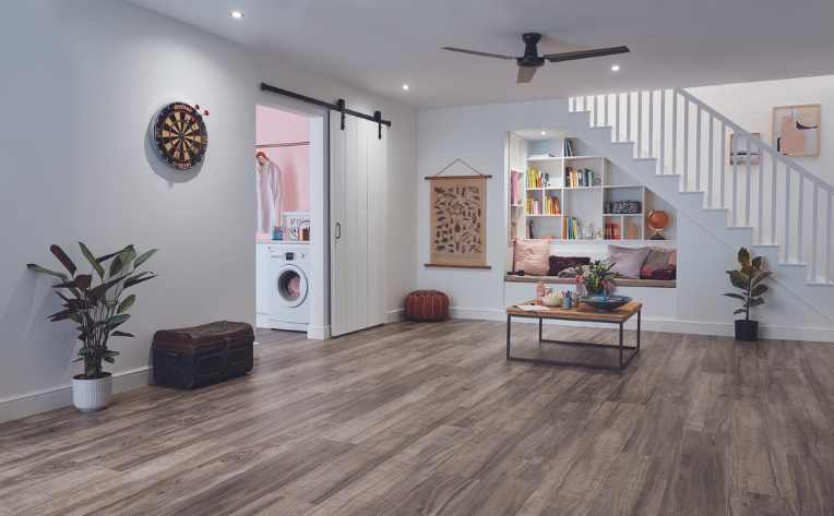cozy finished basement with luxury vinyl and open living space and laundry room